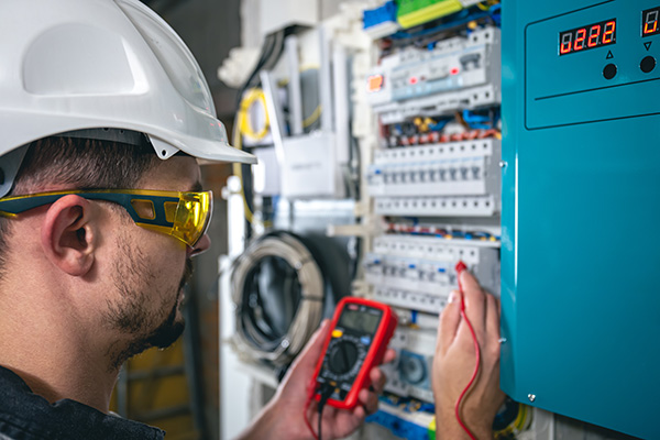 man-an-electrical-technician-working-in-a-switchb-2023-11-27-05-21-23-utc