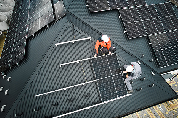 men-workers-installing-solar-panels-on-roof-of-hou-2023-11-27-05-28-24-utc